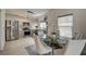 Dining area with glass table and chairs, next to the modern, stainless steel kitchen at 10270 Gilmore Canyon Ct # 202, Las Vegas, NV 89129