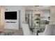 Dining area with a modern kitchen view, featuring a glass table and comfortable chairs at 10270 Gilmore Canyon Ct # 202, Las Vegas, NV 89129