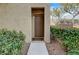 Exterior front door with green bushes and decorative landscaping at 10270 Gilmore Canyon Ct # 202, Las Vegas, NV 89129