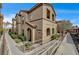 Complex exterior featuring stucco finish, arched entryways, and accessible ramp at 10270 Gilmore Canyon Ct # 202, Las Vegas, NV 89129