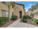 Complex with landscaped walkway leading to the front door, shaded by a small tree at 10270 Gilmore Canyon Ct # 202, Las Vegas, NV 89129