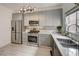 Contemporary kitchen featuring stainless steel appliances, grey cabinetry, and white countertops at 10270 Gilmore Canyon Ct # 202, Las Vegas, NV 89129