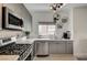 Modern kitchen boasts stainless steel appliances, white countertops, and decorative floating shelves at 10270 Gilmore Canyon Ct # 202, Las Vegas, NV 89129