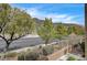 Scenic street view showcasing mature trees, desert landscaping, and mountain views at 10270 Gilmore Canyon Ct # 202, Las Vegas, NV 89129