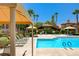 Inviting community pool area with lounge chairs, shaded seating, and well-maintained landscaping at 10270 Gilmore Canyon Ct # 202, Las Vegas, NV 89129
