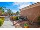 Private courtyard with seating area, mature landscaping, and tile roof at 10640 Mission Lakes Ave, Las Vegas, NV 89134