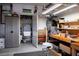 Cluttered garage with storage shelves, workbench, and plastic storage containers at 10640 Mission Lakes Ave, Las Vegas, NV 89134