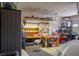 Organized garage area with ample storage and workbench space for projects at 10640 Mission Lakes Ave, Las Vegas, NV 89134