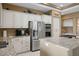 Well-appointed kitchen with stainless appliances, granite counters, and custom cabinetry at 10640 Mission Lakes Ave, Las Vegas, NV 89134
