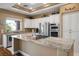 Bright kitchen features granite counters, stainless steel appliances, and ample cabinet space at 10640 Mission Lakes Ave, Las Vegas, NV 89134