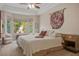 A spacious main bedroom with a sitting area and an abundance of light from the bay window at 10640 Mission Lakes Ave, Las Vegas, NV 89134