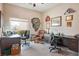 Spacious home office with multiple workstations, a leather chair, and bright natural light at 10640 Mission Lakes Ave, Las Vegas, NV 89134