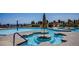 Expansive community pool featuring ample seating and lush landscaping for a resort-like experience at 10640 Mission Lakes Ave, Las Vegas, NV 89134