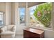 Sitting area with a view of the landscaped yard and flowers viewed from the large window at 10640 Mission Lakes Ave, Las Vegas, NV 89134