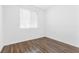 Minimalist bedroom with new vinyl floors and a large window at 10946 Mount Goyer St, Las Vegas, NV 89141