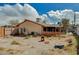 Exterior backyard shot of home and dirt yard with small fencing at 111 Narcissus Ln, Las Vegas, NV 89107