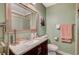 Bathroom featuring a single sink vanity, framed mirror, and a shower at 111 Narcissus Ln, Las Vegas, NV 89107