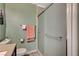 Bathroom with sliding glass shower door, a toilet, and peach colored towels at 111 Narcissus Ln, Las Vegas, NV 89107