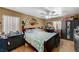 Bedroom with a large bed, wood floors, ceiling fan, and built-in cabinets at 111 Narcissus Ln, Las Vegas, NV 89107