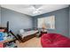 A bedroom with blue walls, a wood floor, and a large red beanbag chair at 111 Narcissus Ln, Las Vegas, NV 89107