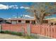 Charming single-story home featuring a large mature tree with a decorative pink fence in the front yard at 111 Narcissus Ln, Las Vegas, NV 89107