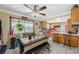 Traditional-style kitchen with a breakfast bar, adjacent dining area, tile flooring, and window with a garden view at 111 Narcissus Ln, Las Vegas, NV 89107