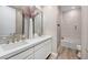 Bright bathroom with double sinks, quartz countertop, and a shower-over-tub with decorative tile surround at 11280 Granite Ridge Dr # 1101, Las Vegas, NV 89135