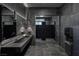 Modern bathroom with sleek design, dark tile, and double sink at 11280 Granite Ridge Dr # 1101, Las Vegas, NV 89135