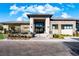 Clubhouse entrance with a brick paved walkway, stone columns, and manicured landscaping at 11280 Granite Ridge Dr # 1101, Las Vegas, NV 89135