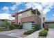 Modern two-story home with a green garage door, brick accents, and a well-maintained front yard at 11280 Granite Ridge Dr # 1101, Las Vegas, NV 89135