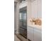 Close-up view of a stainless steel refrigerator integrated into the modern, white-cabinet kitchen design at 11280 Granite Ridge Dr # 1101, Las Vegas, NV 89135