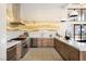 Open kitchen with custom cabinetry, stainless appliances and breakfast bar at 11280 Granite Ridge Dr # 1101, Las Vegas, NV 89135