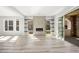 Modern living room with a fireplace, floating shelves, and a sliding glass door leading to a stone patio at 11280 Granite Ridge Dr # 1101, Las Vegas, NV 89135