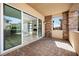 Outdoor patio with brick pavers, stucco pillars, and views into the house and yard at 11280 Granite Ridge Dr # 1101, Las Vegas, NV 89135