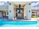 Clubhouse pool with lounge seating, stone accents, and an outdoor fireplace at 11280 Granite Ridge Dr # 1101, Las Vegas, NV 89135
