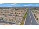 A sprawling neighborhood with two-story homes and red tile roofs and solar panels near large roads at 1131 Orange Meadow St, Las Vegas, NV 89142