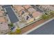 A neighborhood with two-story homes, red tile roofs, solar panels, and a view of a neighboring street at 1131 Orange Meadow St, Las Vegas, NV 89142