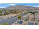 Scenic view of a neighborhood near mountains, featuring well-maintained streets and homes with desert landscaping at 1131 Orange Meadow St, Las Vegas, NV 89142