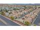 A high angle view of a neighborhood with two-story homes and red tile roofs and solar panels at 1131 Orange Meadow St, Las Vegas, NV 89142