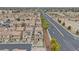 A neighborhood with two-story homes and red tile roofs and solar panels near a large road at 1131 Orange Meadow St, Las Vegas, NV 89142