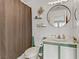 Cozy bathroom featuring a toilet, sink, round mirror, vanity, and a shower with curtain at 1131 Orange Meadow St, Las Vegas, NV 89142