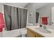 Main bathroom with a shower-tub combo, gray shower curtain, and ample countertop space at 1131 Orange Meadow St, Las Vegas, NV 89142
