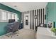 Stripped accent wall in a bedroom featuring a desk and black leather computer chair at 1131 Orange Meadow St, Las Vegas, NV 89142