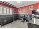 Red-walled bedroom with a work station, shelving, and a window with plantation shutters at 1131 Orange Meadow St, Las Vegas, NV 89142