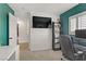 Green-painted bedroom with a desk, computer, and a window with plantation shutters at 1131 Orange Meadow St, Las Vegas, NV 89142