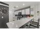 Updated kitchen featuring white cabinetry, breakfast bar, and modern fixtures at 1131 Orange Meadow St, Las Vegas, NV 89142