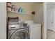Convenient laundry room featuring a modern Samsung washer and dryer set with ample shelving at 1131 Orange Meadow St, Las Vegas, NV 89142