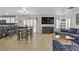 Spacious living area with a sleek entertainment center, eat-in kitchen, and a large sectional sofa at 1131 Orange Meadow St, Las Vegas, NV 89142