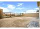 Large backyard space with gravel and brick, fenced for privacy, providing a blank canvas for landscaping and customization at 11676 Midnight Melody Ave, Las Vegas, NV 89138