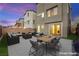 Stylish backyard patio with modern furniture, outdoor dining set, and landscaped yard at 11676 Midnight Melody Ave, Las Vegas, NV 89138